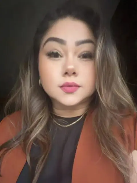 Close-up portrait of woman in brown jacket